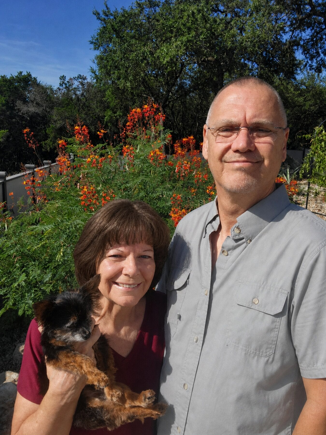Richard and Lori Sprecker with their dog Pill-o in their garden